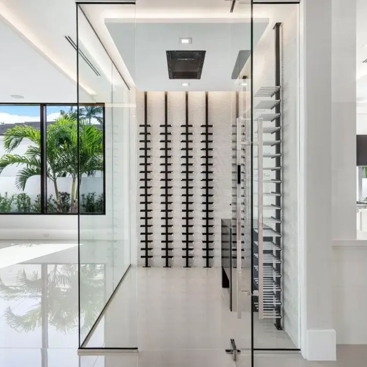 floor-to-ceiling wine post system in modern glass wine room with natural light