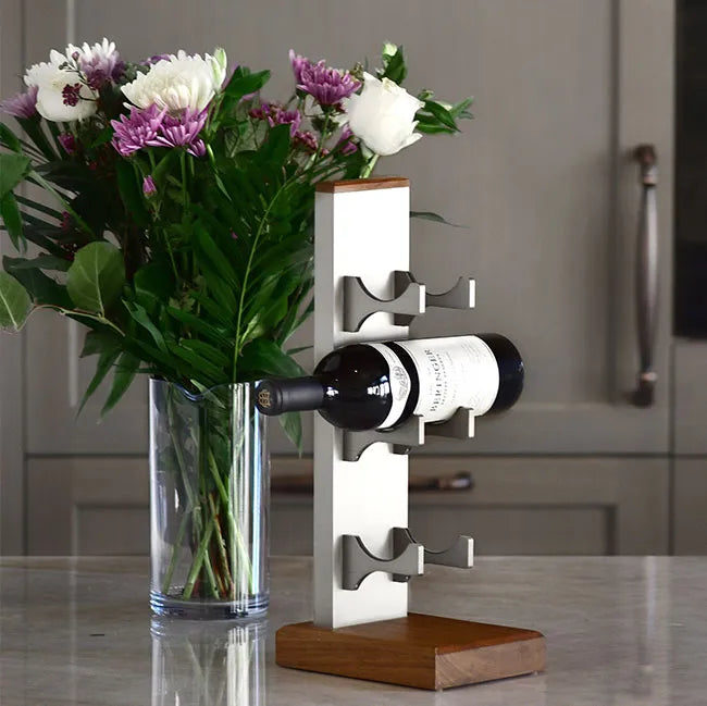 Wine rack with bottles and a vase of flowers on a kitchen counter