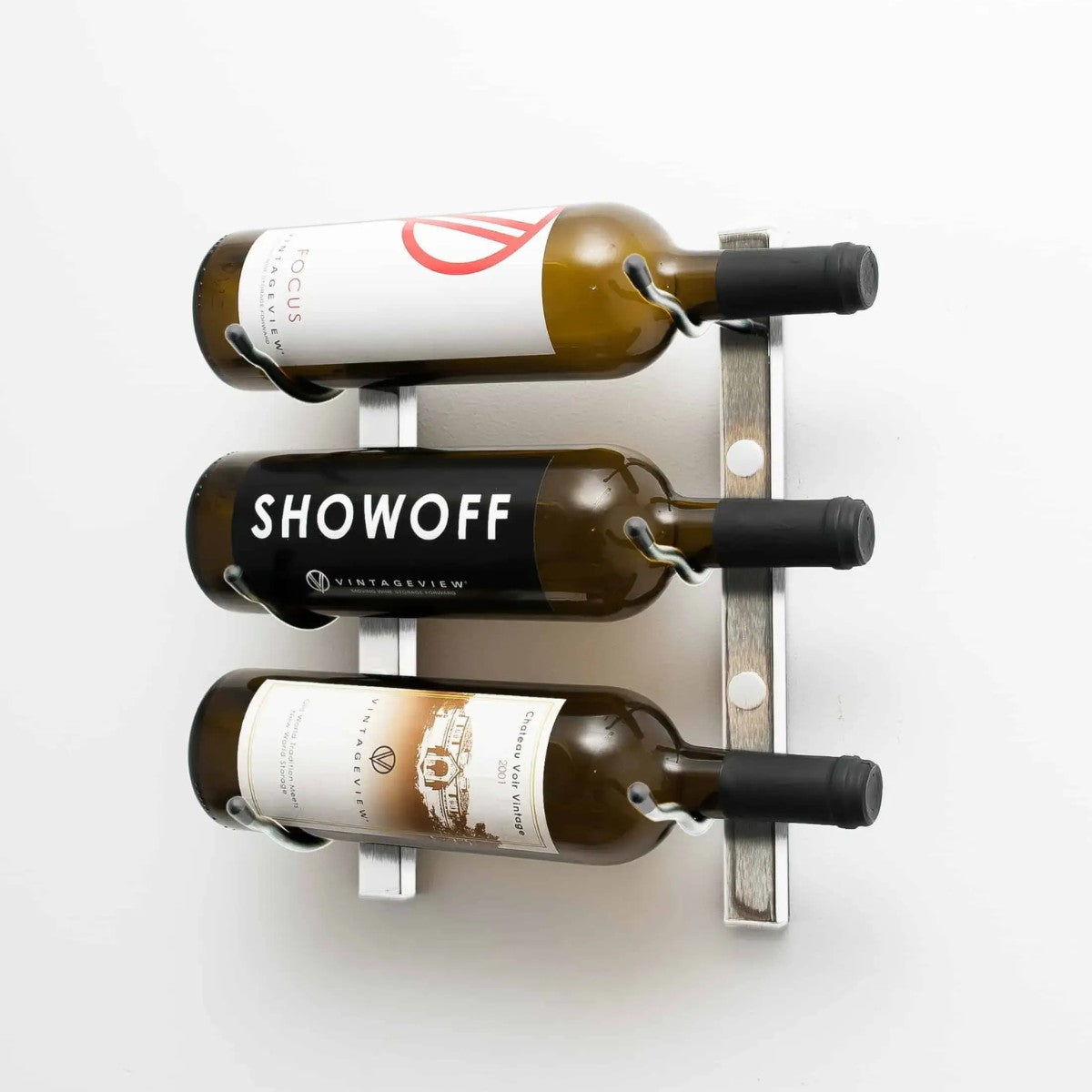 Wall-mounted wine bottle holder with three bottles on a white background