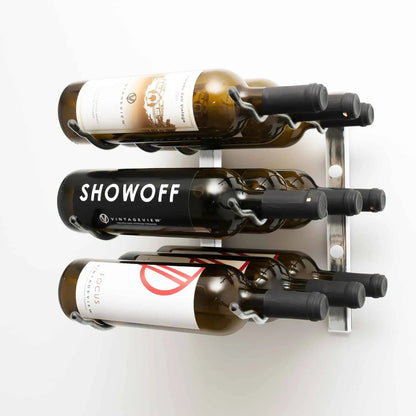 Wall-mounted wine rack holding three bottles of wine on a white background