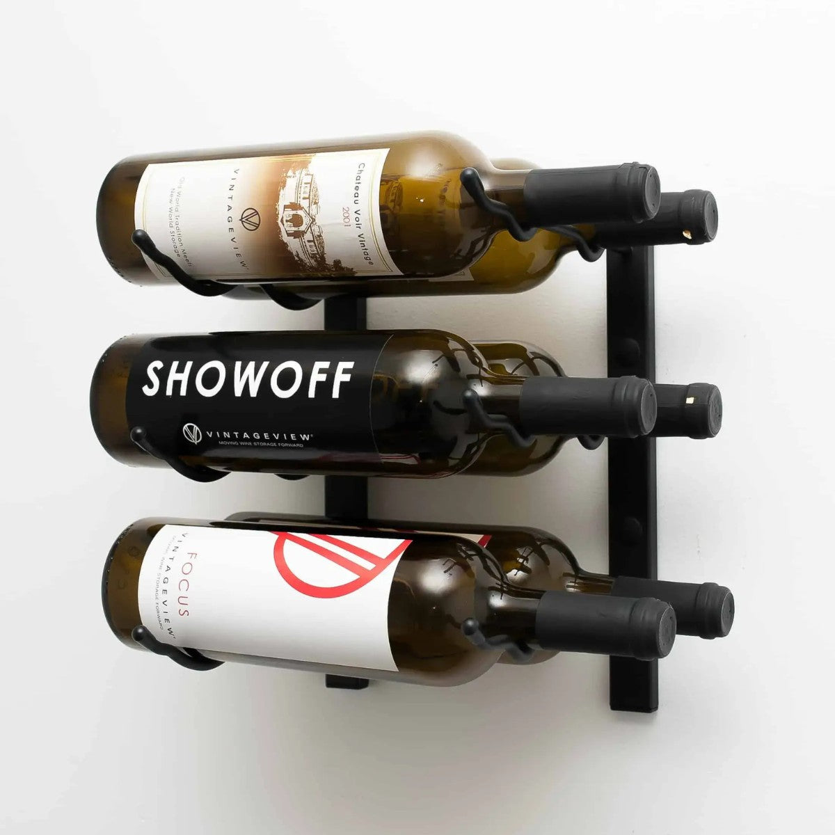 Wall-mounted wine rack holding three bottles of wine on a white background