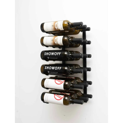 Wall-mounted wine rack holding six bottles of Showoff wine on a white background