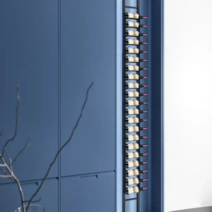 Blue cabinet with a vertical array of small bottles on a light background