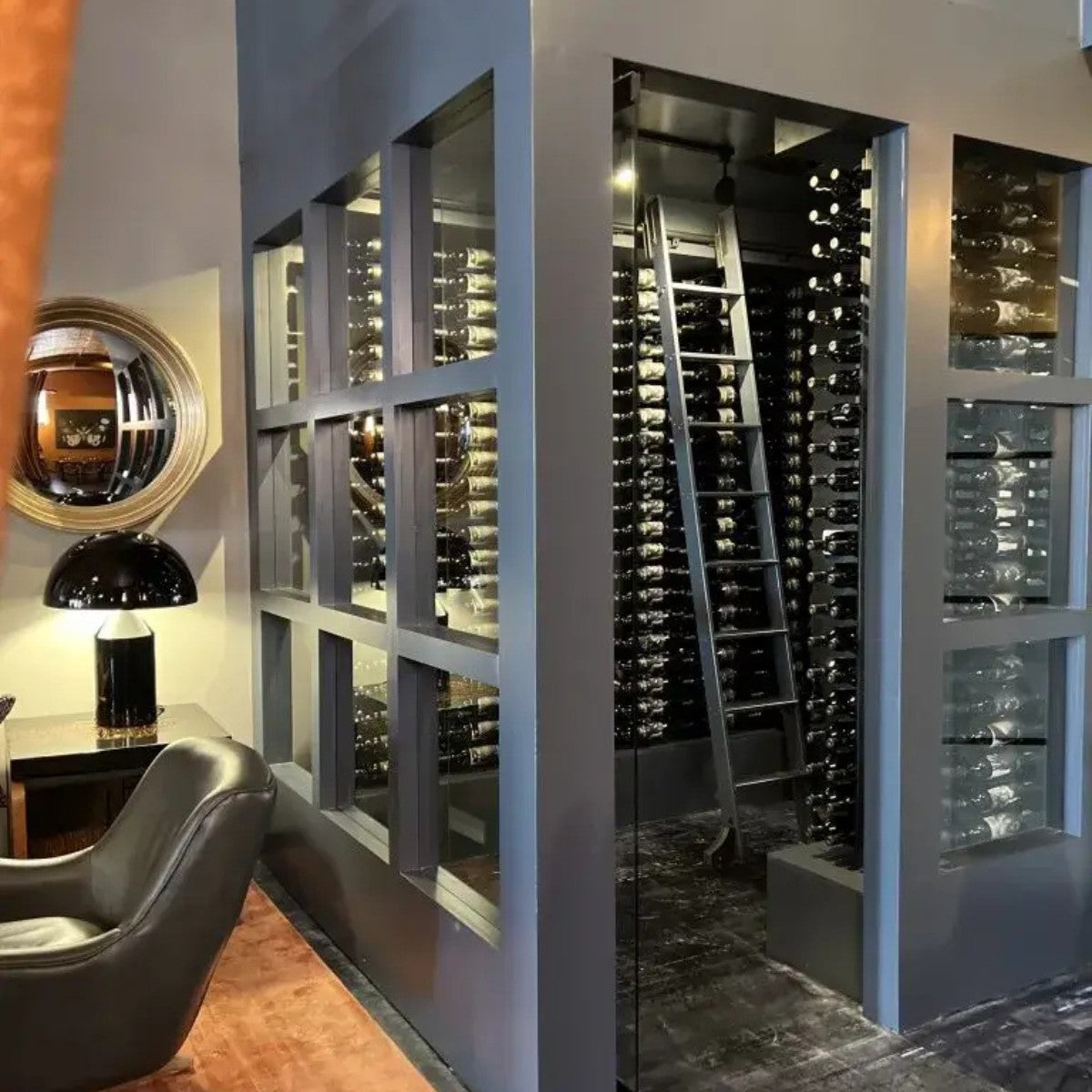 Modern wine cellar with glass panels and a chair in the foreground