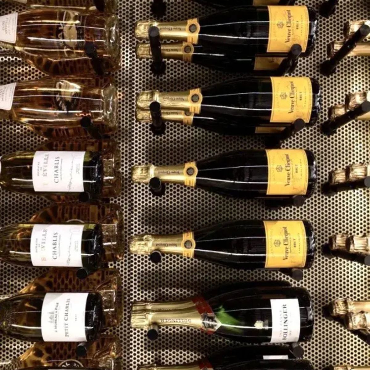Bottles of champagne arranged on a metal grid
