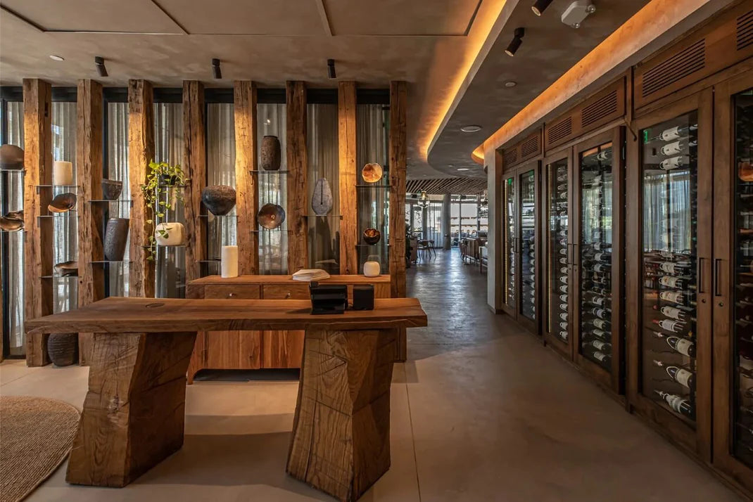 Commercial wine cabinet wall with glass doors showcased in a luxury restaurant interior with rustic wood design elements.