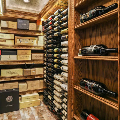 Custom wine cellar with label-forward wall-mounted wine racks and wood shelving for bottle and case storage