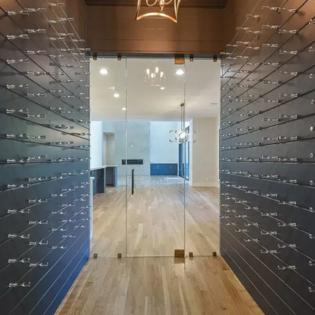 Modern wine cellar wall featuring clear acrylic Vino Pins creating a sleek label-forward bottle display