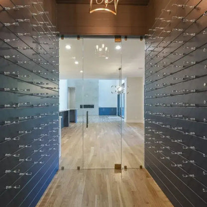 Modern wine cellar wall featuring clear acrylic Vino Pins creating a sleek label-forward bottle display