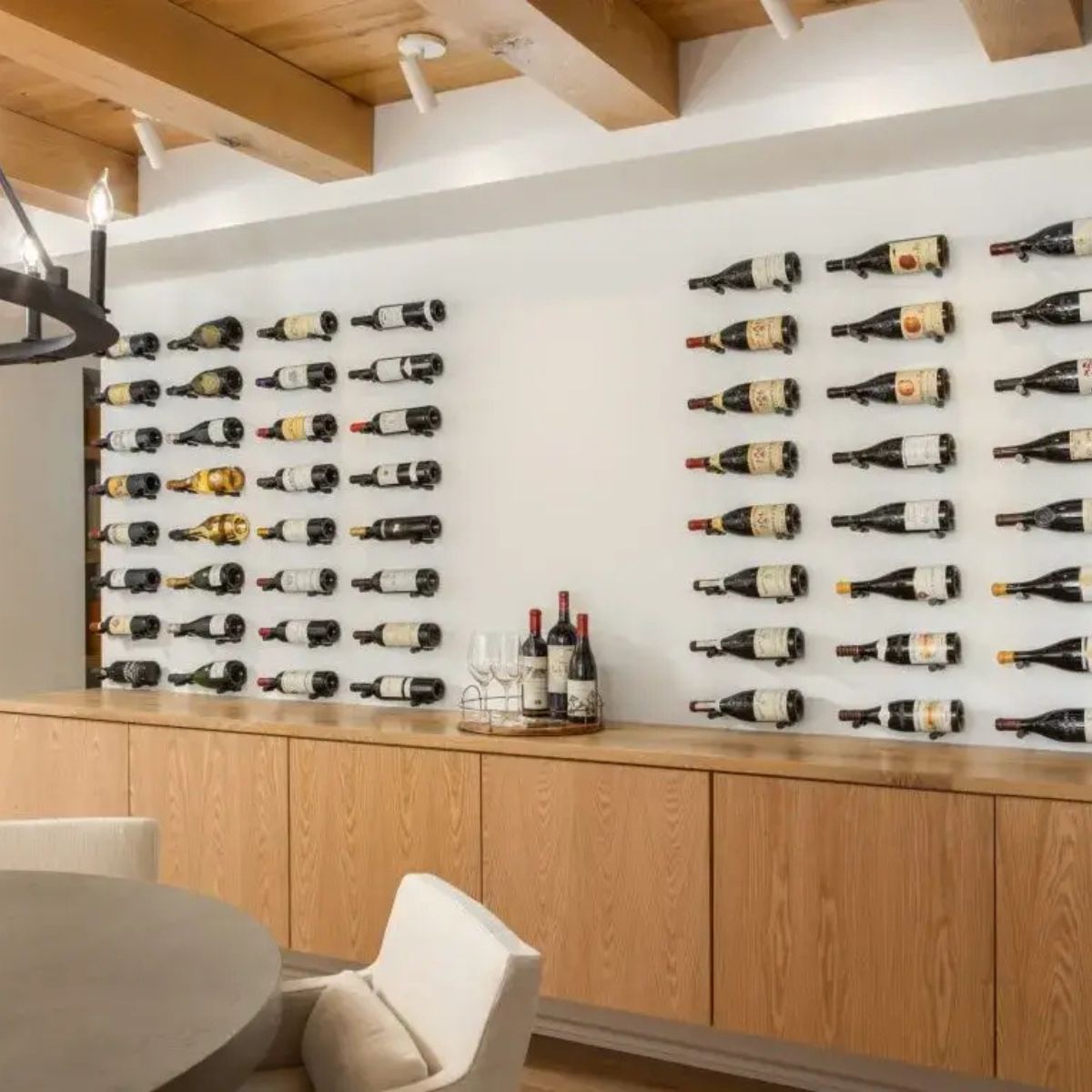 Wine bottles displayed on a wall in a modern interior setting.