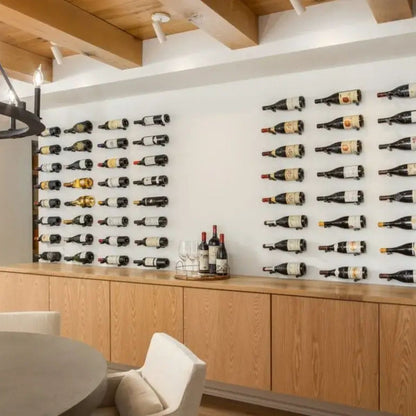 Wine bottles displayed on a wall in a modern interior setting.