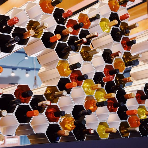 Wine bottles arranged in a honeycomb pattern on a white background