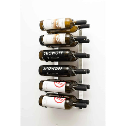 Wall-mounted wine rack with six bottles of Showoff wine on a white background
