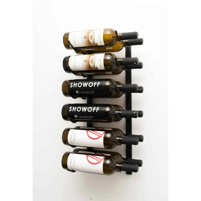 Wall-mounted wine rack with six bottles of Showoff wine on a white background